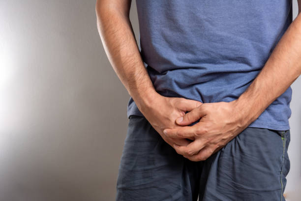 Close up of a man with hands holding his crotch, Urinary Tract Infection concept Painful Bladder Syndrome and interstitial cystitis sick middle aged man with prostate cancer, prostate inflammation, premature ejaculation, fertility, bladder problem sickness, man health care and prostate senior man health issue well being concept urinal male toilet public restroom healthy lifestyle stock pictures, royalty-free photos & images