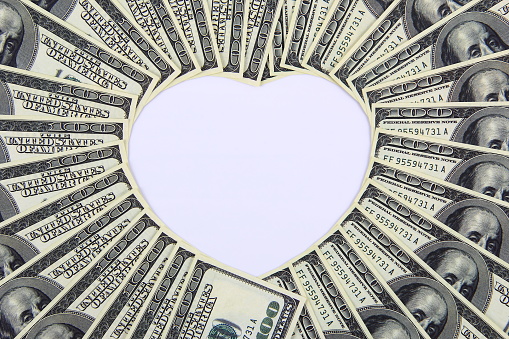 Money in shape of heart, love and money