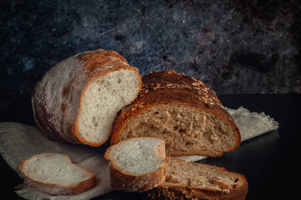 istock Fresh bread with bran, seeds and oatmeal on the table 1272095000
