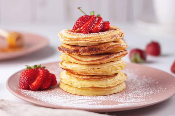 Delicious, only baked pancakes with fresh aromatic strawberries Freshly baked pancakes with strawberries on a natural wood background pancake photos stock pictures, royalty-free photos & images