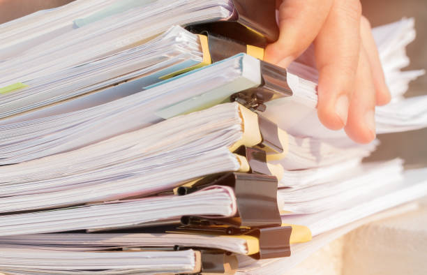 istock Document Report and business busy Concept: Asian Businessman hands working in many documents Stacks of folders in office for Annual Report files, Piles of unfinish sheet folder close annual budget. 1272099993