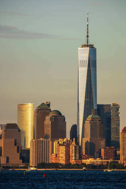 Lower Manhattan and the Freedom Tower The Freedom Tower from the 9/11 Teardrop Memorial to the struggle against world terrorism statue photos stock pictures, royalty-free photos & images