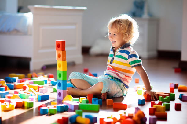 istock Child playing with colorful toy blocks. Kids play. 1272103949