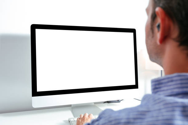 istock Business man working on computer with blank screen at office desk 1272104007