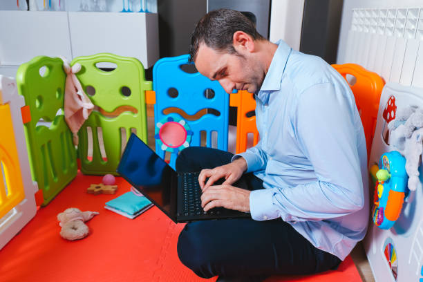 istock Businessman has fallen asleep sitting inside baby's playground at home 1272104013