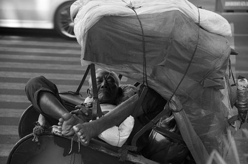 Rickshaw driver in Surakarta, Indonesia, taking a rest in his cab on September 15 2014.
