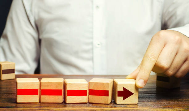 istock Man builds an arrow from blocks. Business development, growth process concept. Career promotion, improving skills. Business building and expansion. Goal achievement. Progress and movement forward. 1272104317