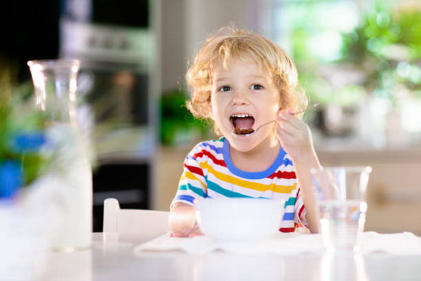 istock Child eating breakfast. Kid with milk and cereal. 1272105161