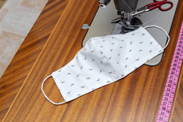 istock Woman's hands sewing face masks on for protection 1272110462