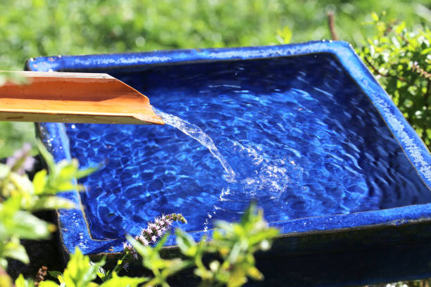 istock Water runs over a bamboo into a blue bowl 1272111361