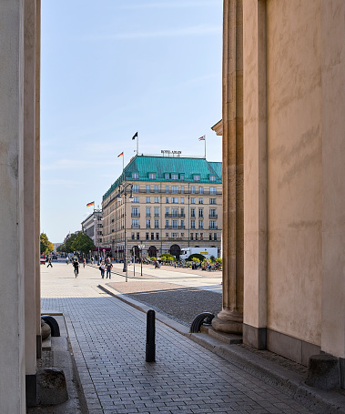 Berlin, Germany - September 11, 2020: View from the passage of the Brandenburg Gate onto the Pariser Platz with the Hotel Adlon Kempinski in the background in Berlin Mitte (formerly East Berlin)