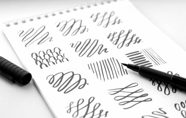 istock Vertical and horizontal lines are drawn with a black liner on white pape 1272112263
