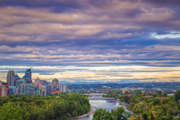 Sunrise Cloudscape Over Downtown Calgary A colorful cloudy sky over downtown Calgary and the Bow river in the summer. bow river stock pictures, royalty-free photos & images