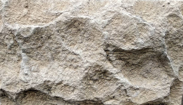 istock the texture of a single uneven stone surface is light yellow with light streaks and depressions for the background 1272116691