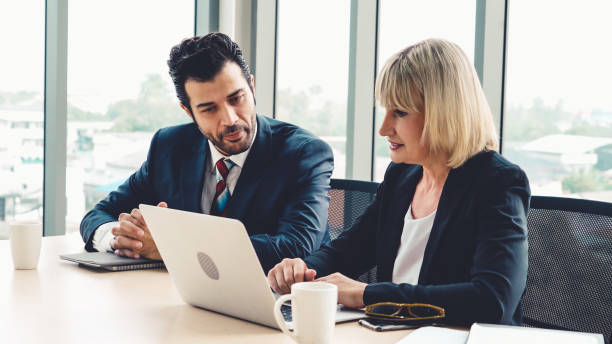 istock Two business people talk project strategy at office 1272116815