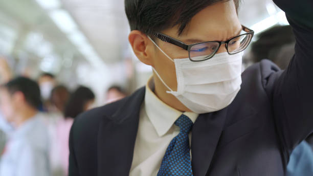 istock Young man wearing face mask travels on crowded subway train 1272117117
