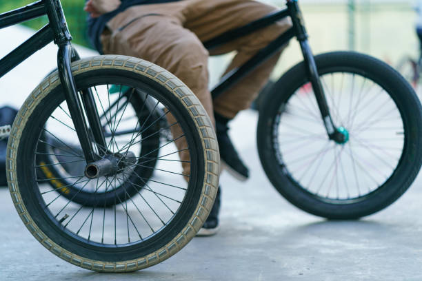 Low section of boy riding BMX bicycle