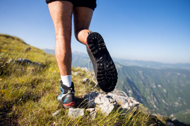 istock Low angle view of hiker walking up to mountain 1272117691