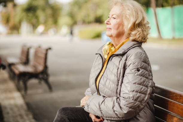 istock Lonely senior woman in park 1272118104