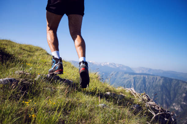 istock Low angle view of hiker walking up to mountain 1272118111