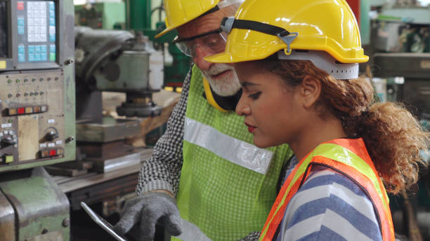 istock Group of factory workers using machine equipment in factory workshop 1272118112
