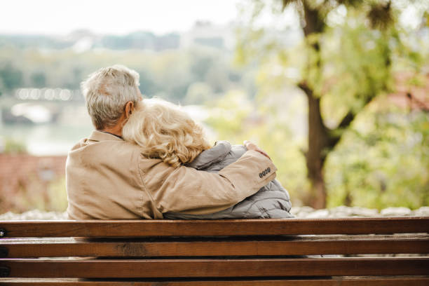 istock Happy seniors on the bench in park 1272118139