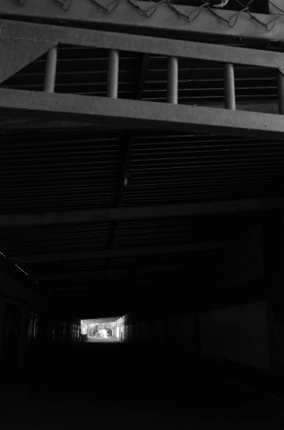 istock Dark corridor with the light in the end 1272118455