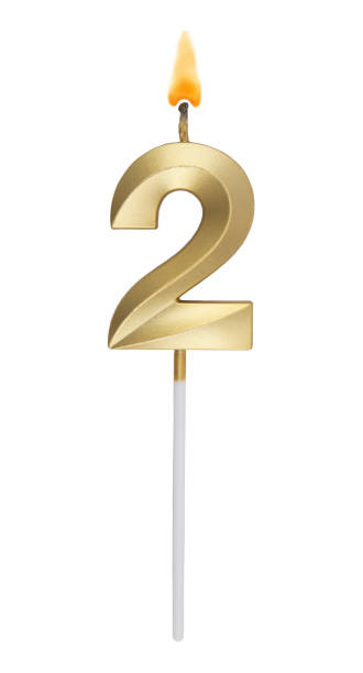 istock Golden birthday candle isolated on white background, number 2 1272122366