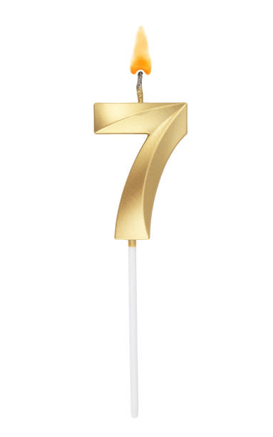 istock Golden birthday candle isolated on white background, number 7 1272122377