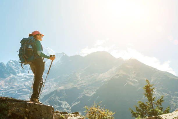 istock Young hiker backpacker female using trekking poles enjoying mountain view during high altitude Acclimatization walk. Everest Base Camp trekking route, Nepal. Active vacations concept image 1272123023