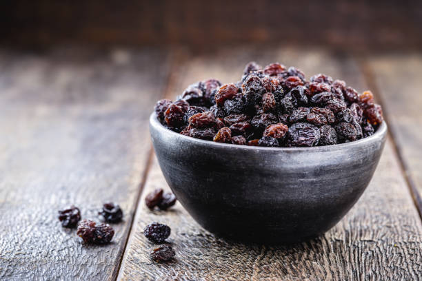 istock crystallized and dehydrated dry grapes, christmas dessert inside a clay pot, rustic wooden background and space for text 1272129299