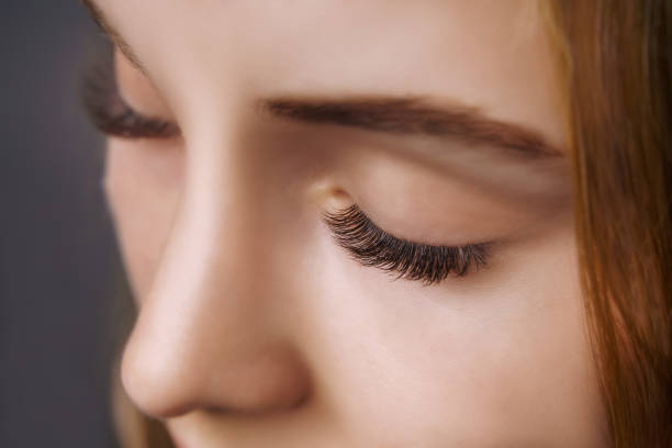 istock Eyelash Extension Procedure. Woman Eye with Long Eyelashes. Close up, selective focus 1272130574