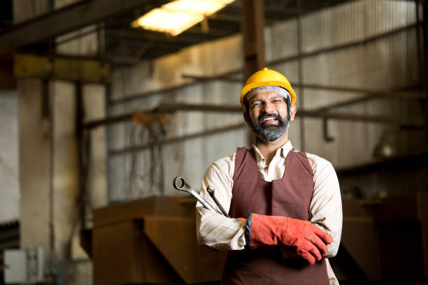 istock Industrial worker holding wrench 1272131524