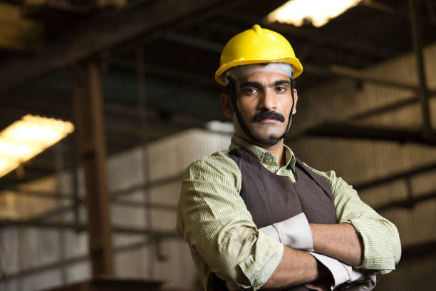 istock Confident industrial worker in protective workwear at factory 1272131719