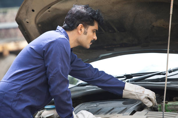 istock Auto mechanic examining engine of car 1272132564