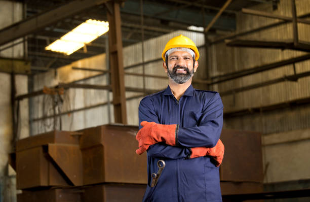 istock Confident industrial worker in protective work wear at factory 1272133538
