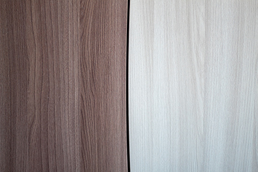A wooden background of two planks of brown and white hue.