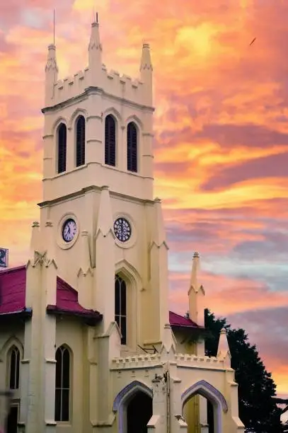 Photo of Christ church shimla shot against a cloudy sky during morning