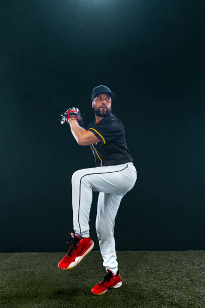 istock Baseball player on dark background. Ballplayer portrait. 1272135271