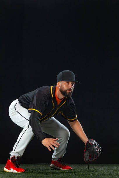 istock Baseball player on dark background. Ballplayer portrait. 1272135838