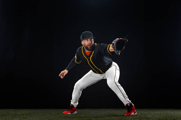 istock Baseball player on dark background. Ballplayer portrait. 1272135893