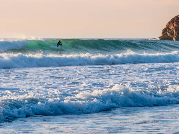 istock A surfer surfing a wave in Cornwall as the sunsets 1272140084