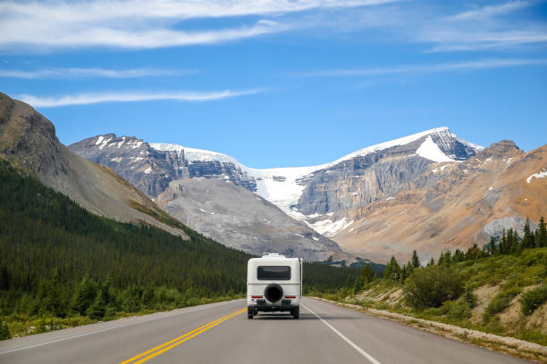 A motorhome making it's way through the Rocky Mountains in Jasper National Park A motorhome making it's way through the Rocky Mountains in Jasper National Park motor home photos stock pictures, royalty-free photos & images