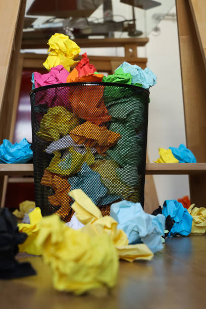 istock Basket Garbage Bin full of papers 1272143213