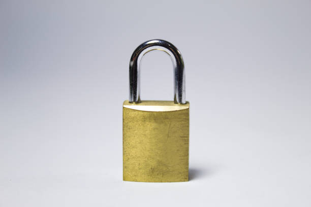 istock Golden metal padlock with white background 1272143334