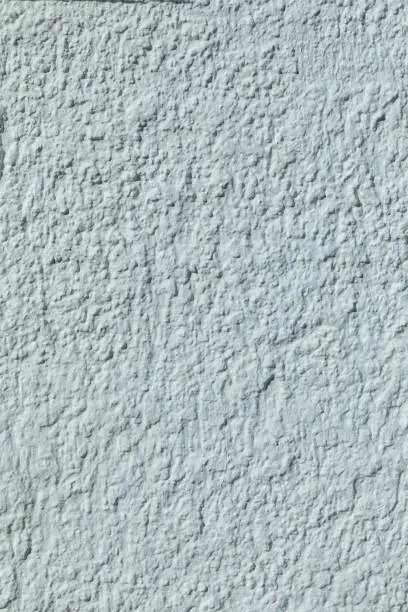 background of grey colored harmonic plaster wallbackground of blue painted plaster wall with rough grainy structure