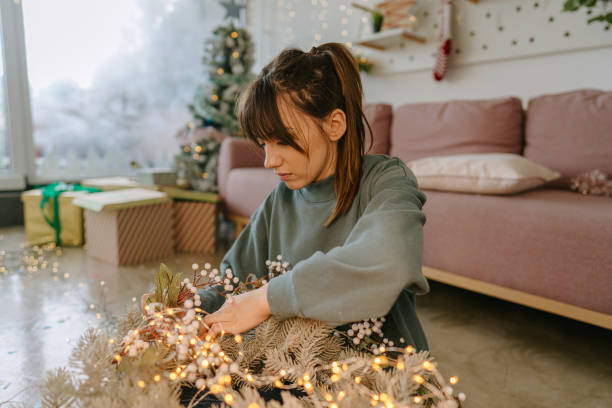 istock Young woman making a Christmas wreath 1272144558