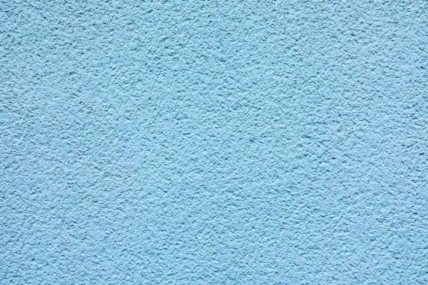 harmonic pattern of blue painted plaster wall