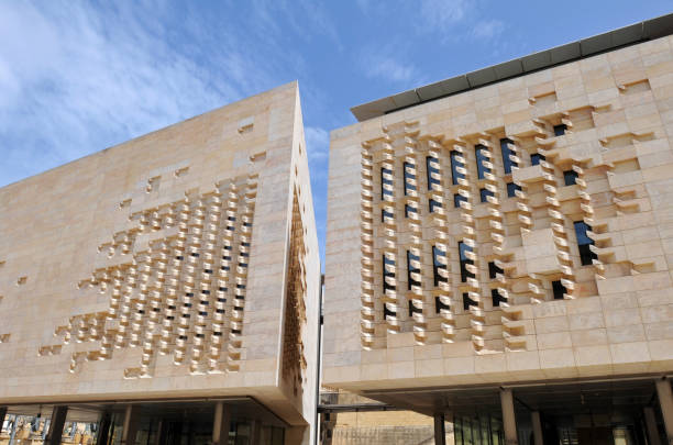 Valletta, Malta, May 18, 2019: The limestone facade of Parliament House in Valletta. The modern building, the meeting place of the Maltese parliament, was designed by architect Renzo Piano and opened in 2015.