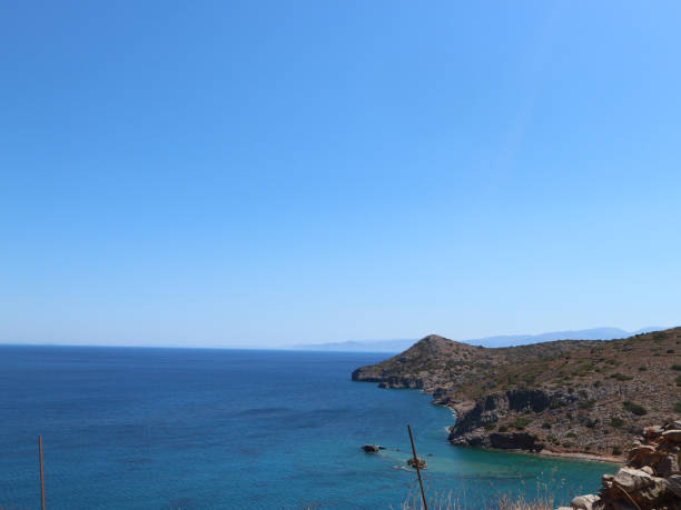 istock Dark Blue Ocean with Small Mountain on the Right Hand Side 1272149072